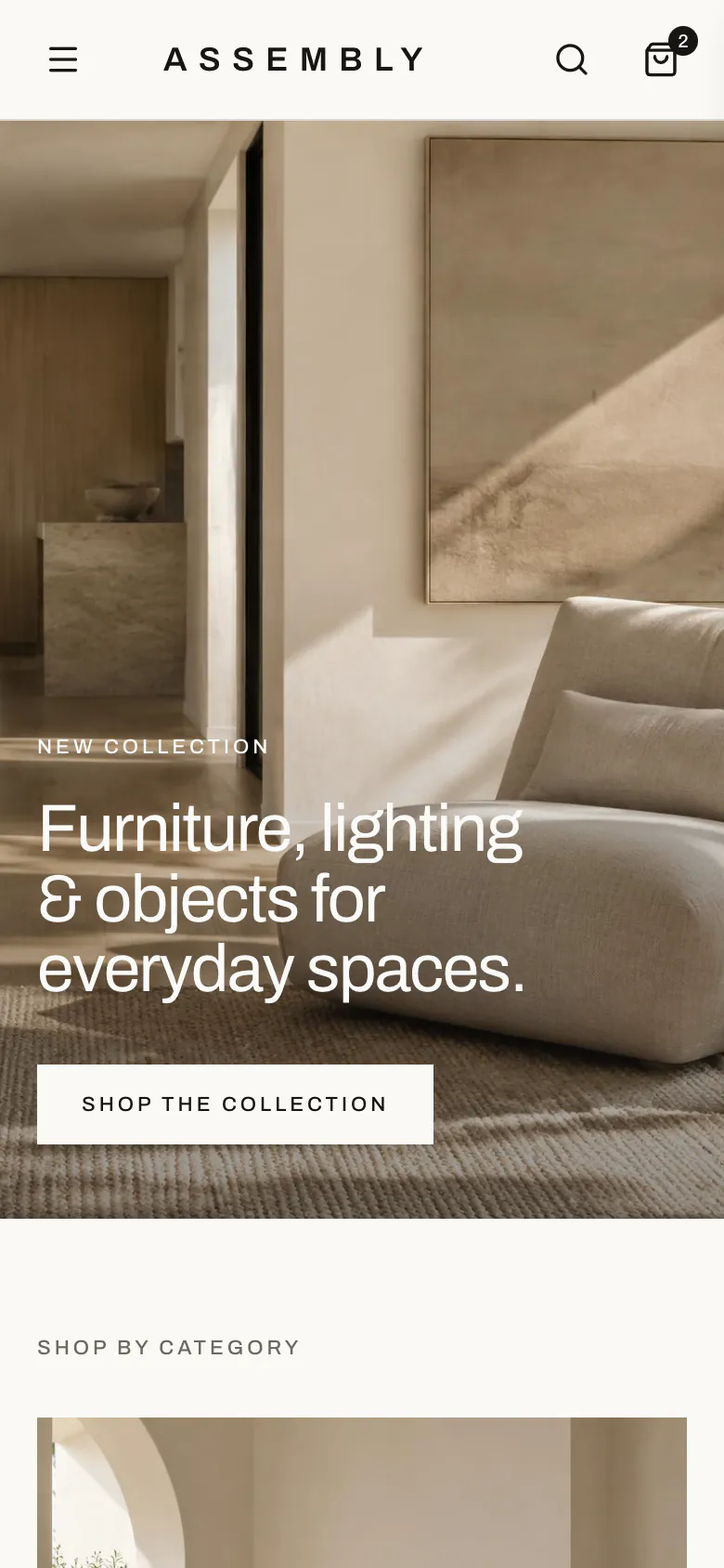Assembly homepage on a phone, with the hero photograph, headline and Shop the Collection button above the start of Shop by Category
